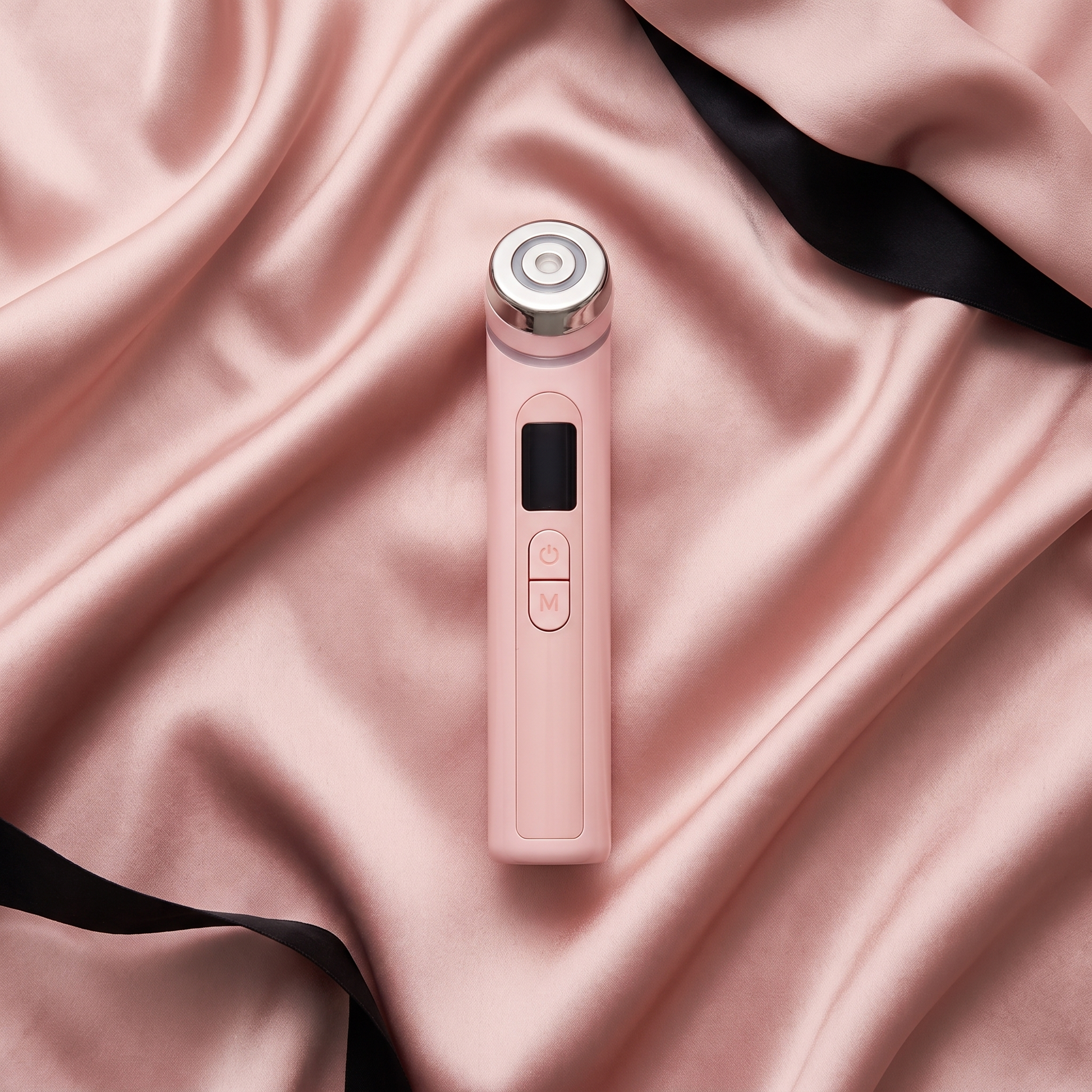 Portable Glow Booster flat lay on silk fabric